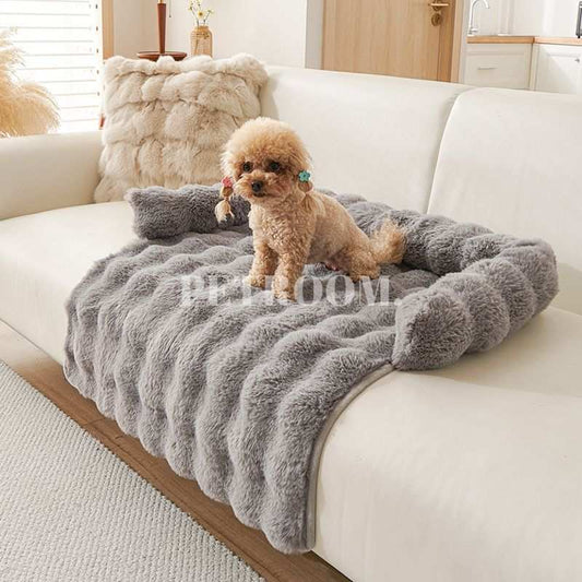 A grey Dog bed with a beige dog on a couch