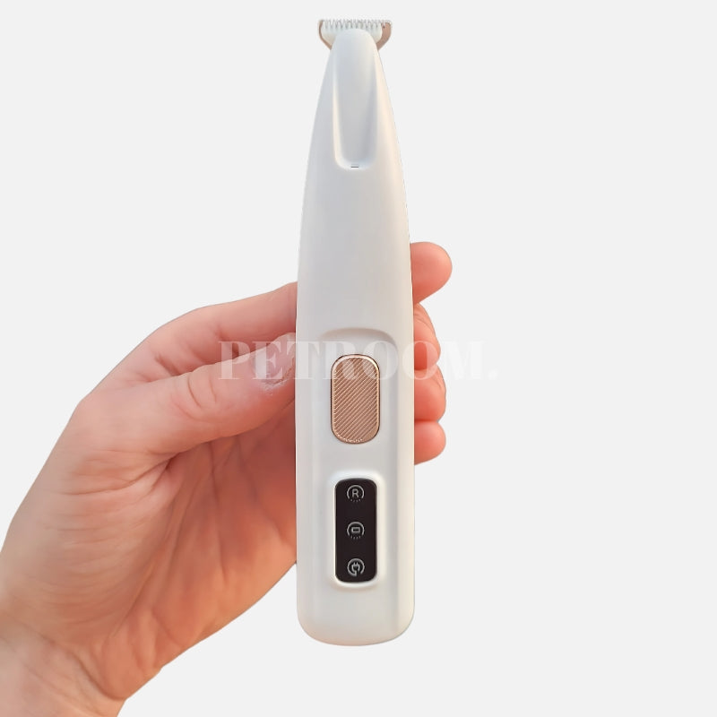 A white Dog Paw Trimmer with a human hand